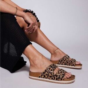 Danny Go Size 10 leopard-print double-buckle footbed sandals.